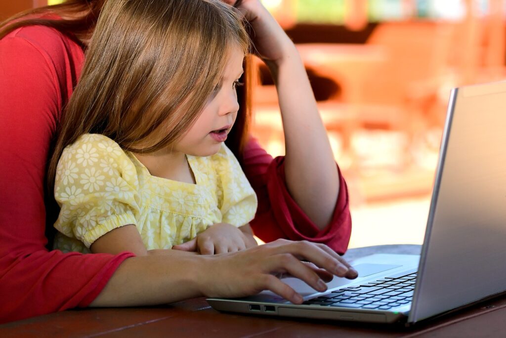 child on computer with parent