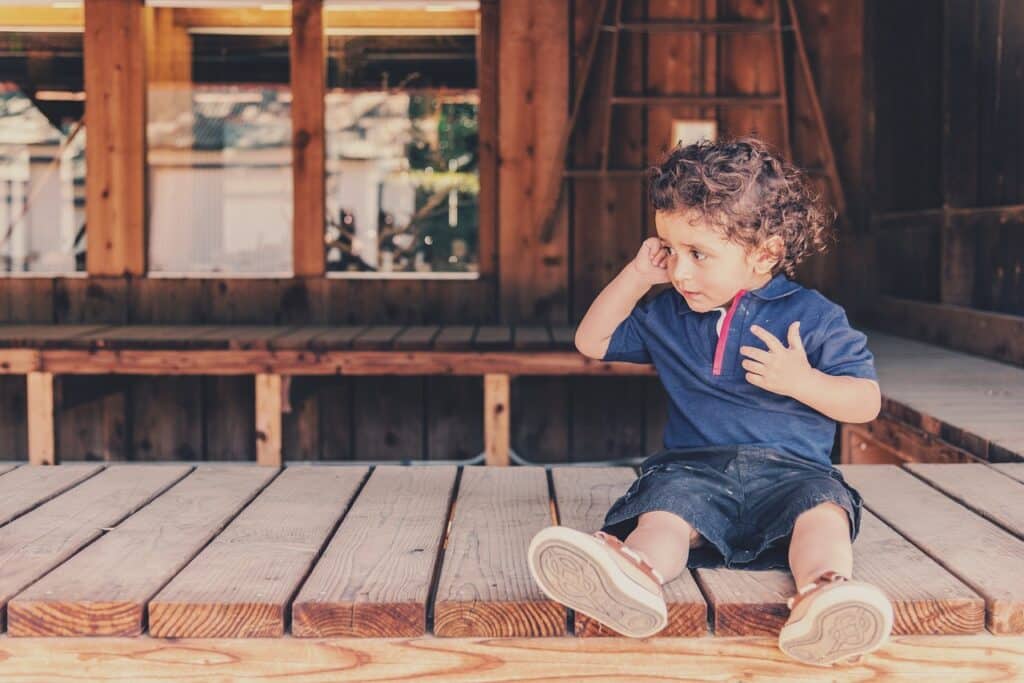 child sitting on deck