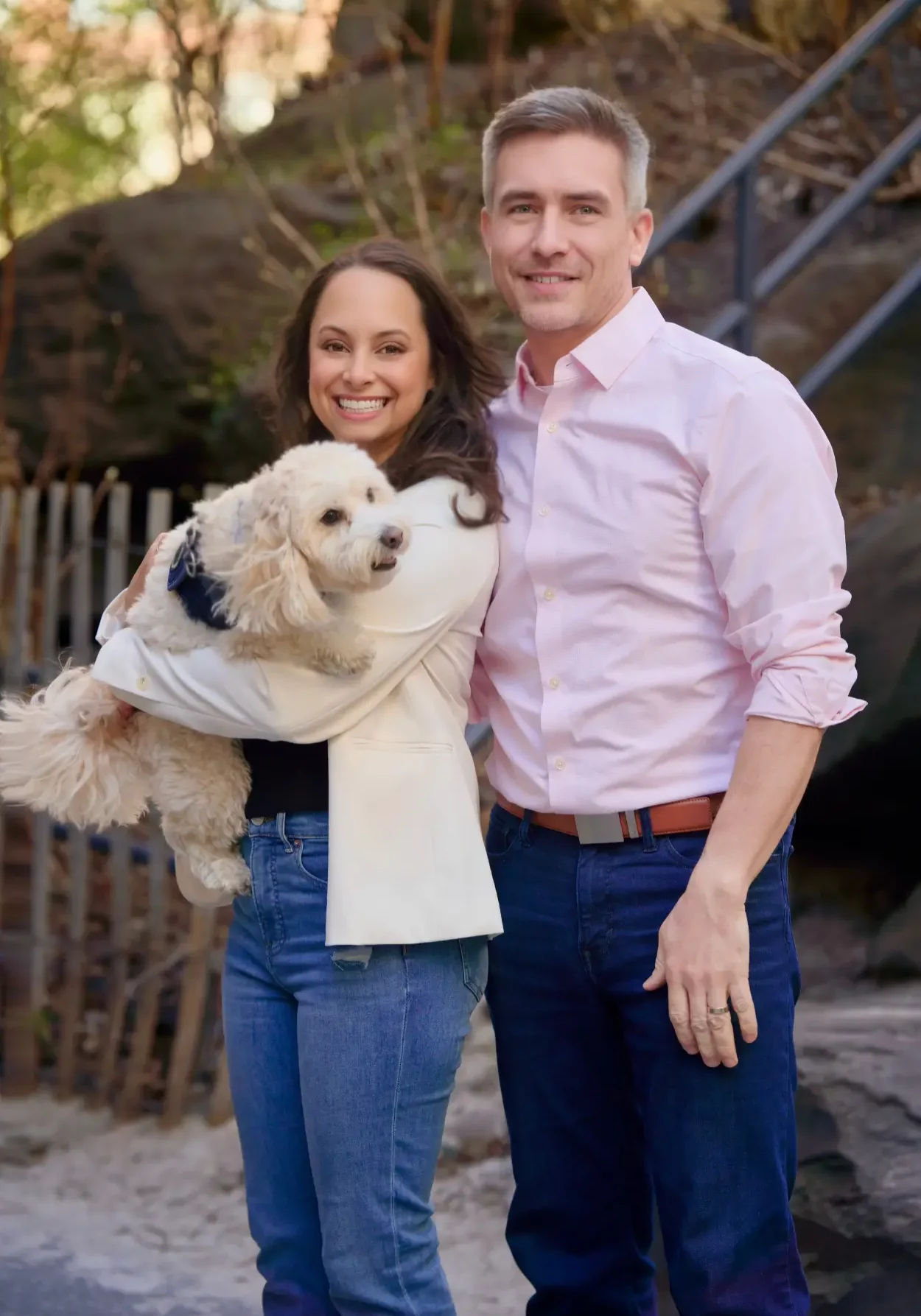 Dr. Elliston and Nurse Heidi smiling holding their dog